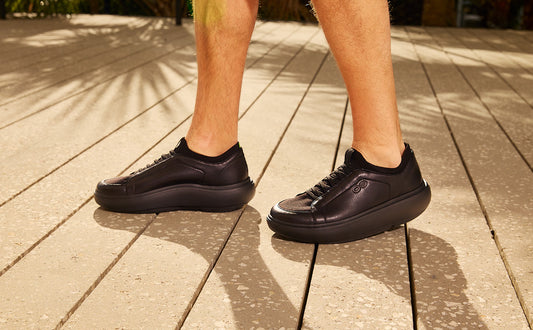 Black sneakers on a wooden floor | lifestyle