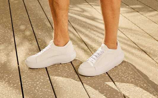 White sneakers on a wooden floor | lifestyle
