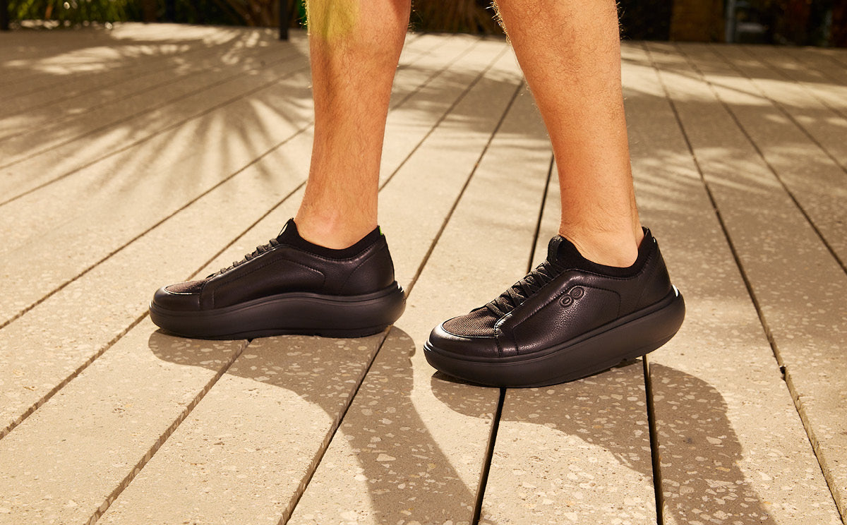 Black sneakers on a wooden floor | lifestyle