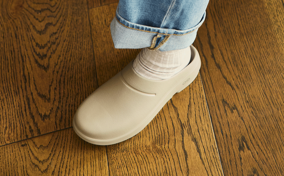 Women's OOcloog Clog - Nomad close up of shoe on model standing on hardwood floor | lifestyle