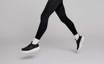 Women's OOmy Zen - Chalk Black model leaping in studio | lifestyle