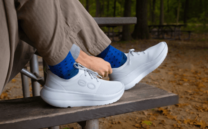 Men's OOmy Stride - Glacier model sitting on bench at campsite | lifestyle