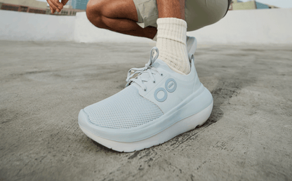 Men's OOmy Stride - Glacier close up of shoe on model outside | lifestyle