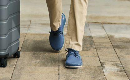 Men's OOmy Stride - Moroccan Blue front view of model walking outside with suitcase | lifestyle