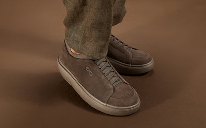 model standing in brown studio wearing suede truffle club plus | lifestyle