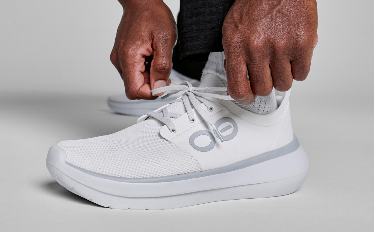 Men's OOmy Stride - White close up of shoe on model in studio | lifestyle