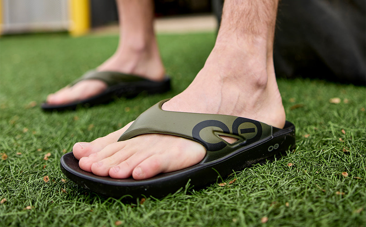 Men's OOriginal Sport Sandal - Tactical Green Lifestyle close up of model wearing shoe outside | lifestyle
