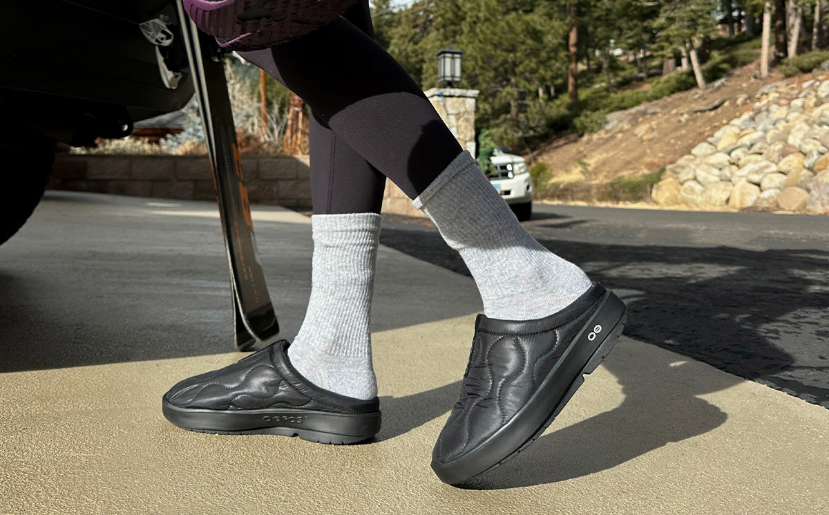 Women's OOcoozie Thermo Mule - Black side view on model walking outside | lifestyle