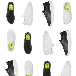Black and white sneakers with green accents arranged in a grid on a white background