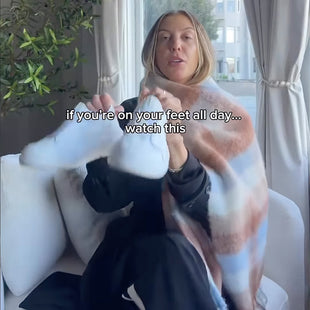 Woman sitting on a couch with a blanket draped over her, text overlay about comfort