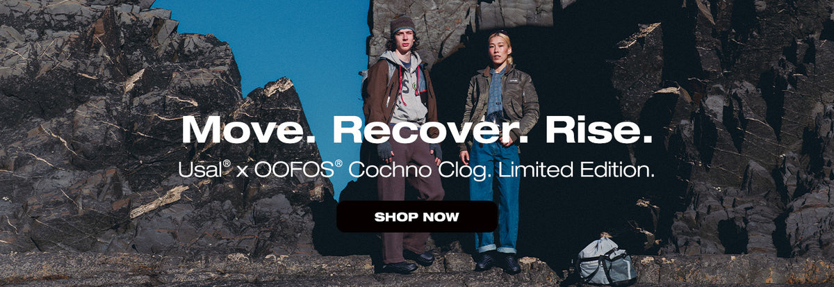 Two people standing on a rocky cliff with promotional text for Usual x OOFS Cochoo Clog Limited Edition.