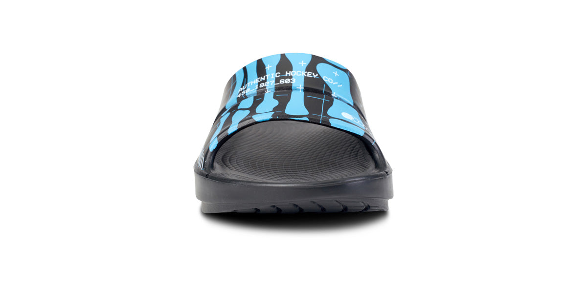 BAUER/OOFOS Women's OOahh Limited Slide Sandal Bauer Skeleton close up of model wearing shoes