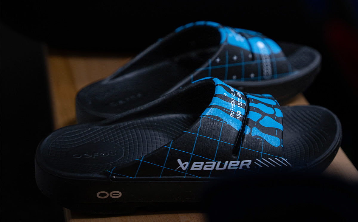 BAUER/OOFOS Men's OOahh Limited Slide Sandal Bauer Skeleton side view close up of shoes